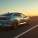 Volkswagen ID.7 electric sedan side profile on open road at golden hour