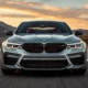 2026 BMW M5 G90 silver sedan front three-quarter view on open road