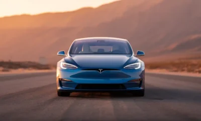 Tesla Model S 2026 luxury electric sedan in Frost Blue Metallic on open highway at golden hour