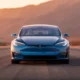 Tesla Model S 2026 luxury electric sedan in Frost Blue Metallic on open highway at golden hour
