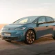 Volkswagen ID.3 GTX electric hot hatch in Midnight Blue on an open coastal road at golden hour
