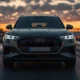 2027 Audi SQ6 e-tron electric SUV front three-quarter view on wet motorway at golden hour