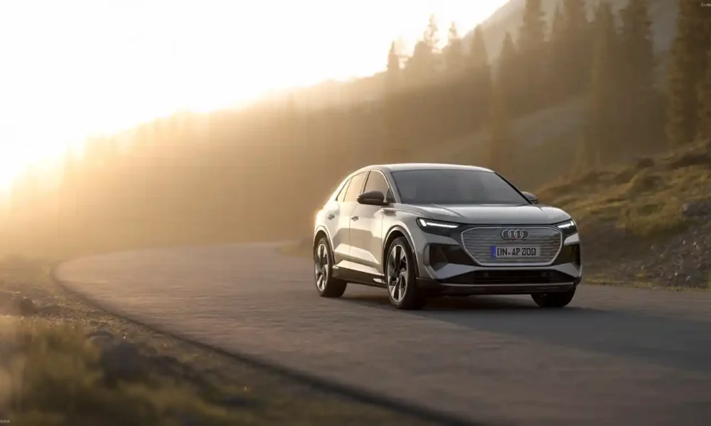 2026 Audi Q4 e-tron electric SUV parked on mountain road at golden hour