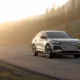 2026 Audi Q4 e-tron electric SUV parked on mountain road at golden hour