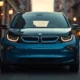 BMW i3 electric car parked on city street, front three-quarter view in Le Castellet Blue