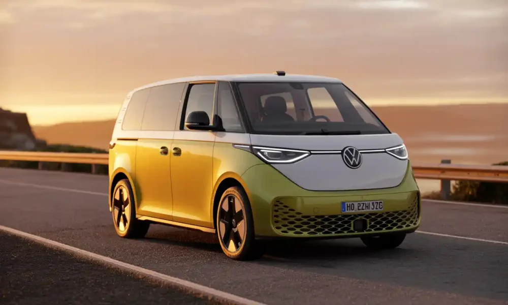2026 VW ID. Buzz problems and common issues — white electric van parked on coastal highway at golden hour