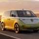 2026 VW ID. Buzz problems and common issues — white electric van parked on coastal highway at golden hour