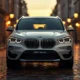 BMW iX1 2026 electric SUV front view in Alpine White on wet European street