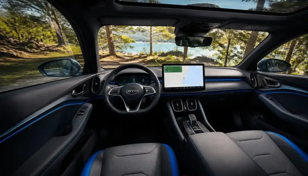 BYD Atto 3 electric vehicle interior showing 15.6-inch rotating touchscreen and guitar-string door pocket with ambient lighting