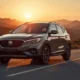 MG4 Electric Review in Meteor Grey on a mountain pass at golden hour in a cinematic wide shot.