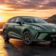 2026 MG4 XPOWER in matte Hunter Green parked on a coastal road at golden hour