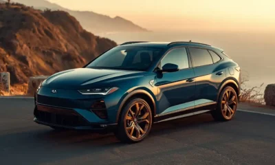 2026 Cupra Tavascan electric SUV coupe in blue on a coastal mountain road at golden hour