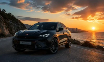 A black CUPRA Terramar 2026 parked on a cliff edge with the sun setting behind it.